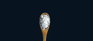 Spoonful of salt, representing the powdered sodium hydroxide we use to make our mens solid shampoo
